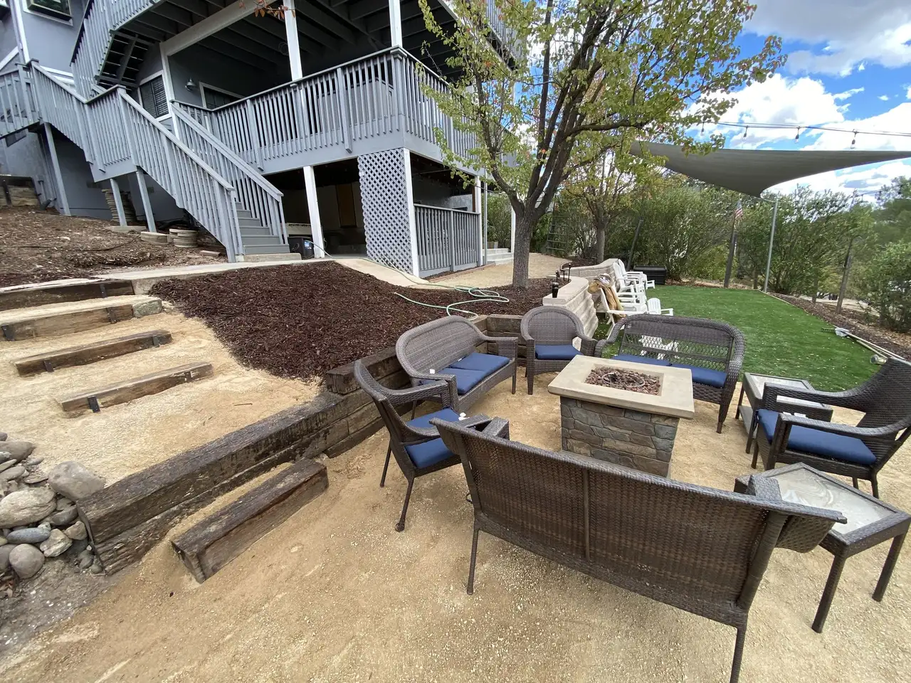 Decomposed granite fire pit patio with wicker seating