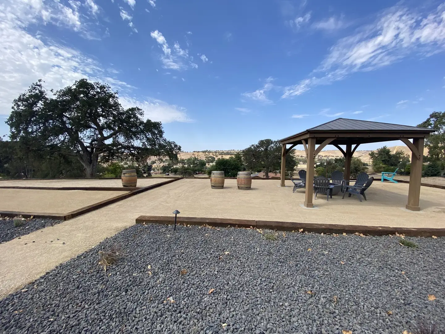 Gazebo on a decomposed granite patio with wine barrel planters