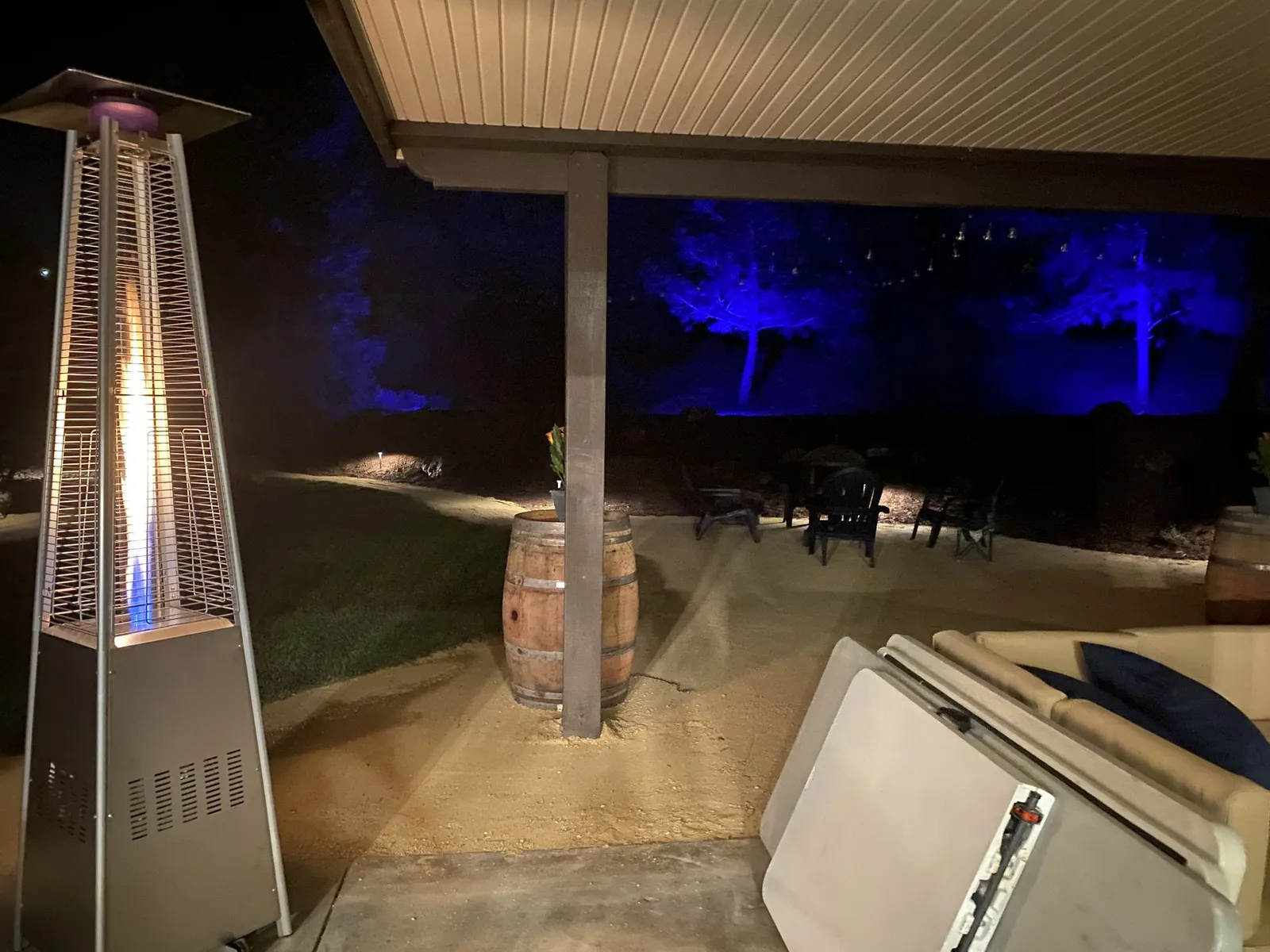 Patio at night with a heater and uplighting on an oak