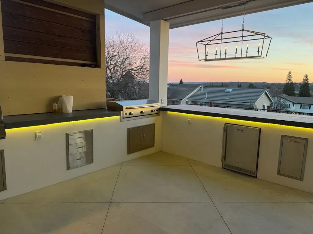Outdoor kitchen with LED lighting at sunset