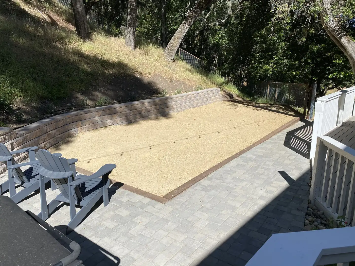 Paver walkway beside a decomposed granite court and a segmental block retaining wall