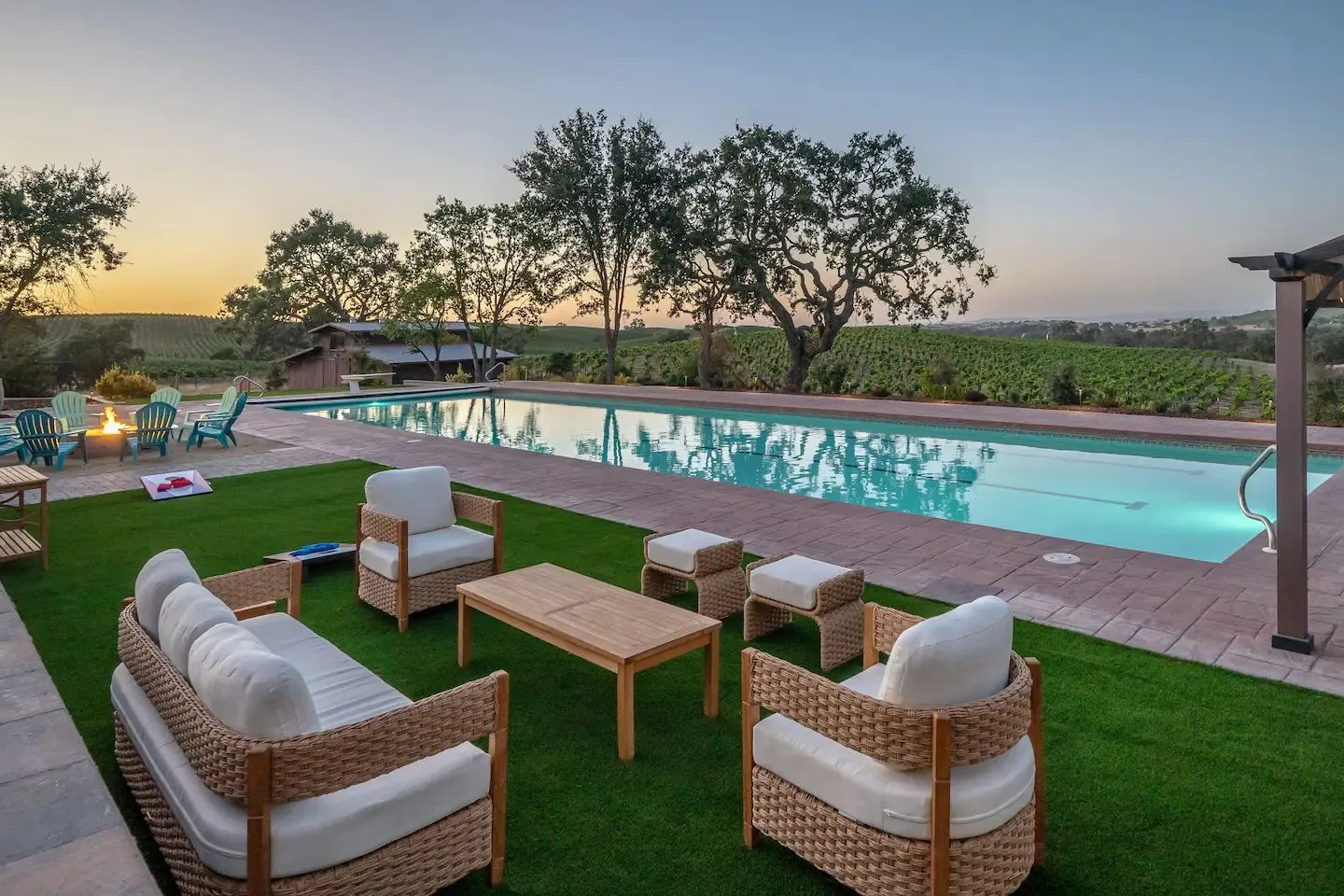 Backyard pool with an artificial turf lounge area