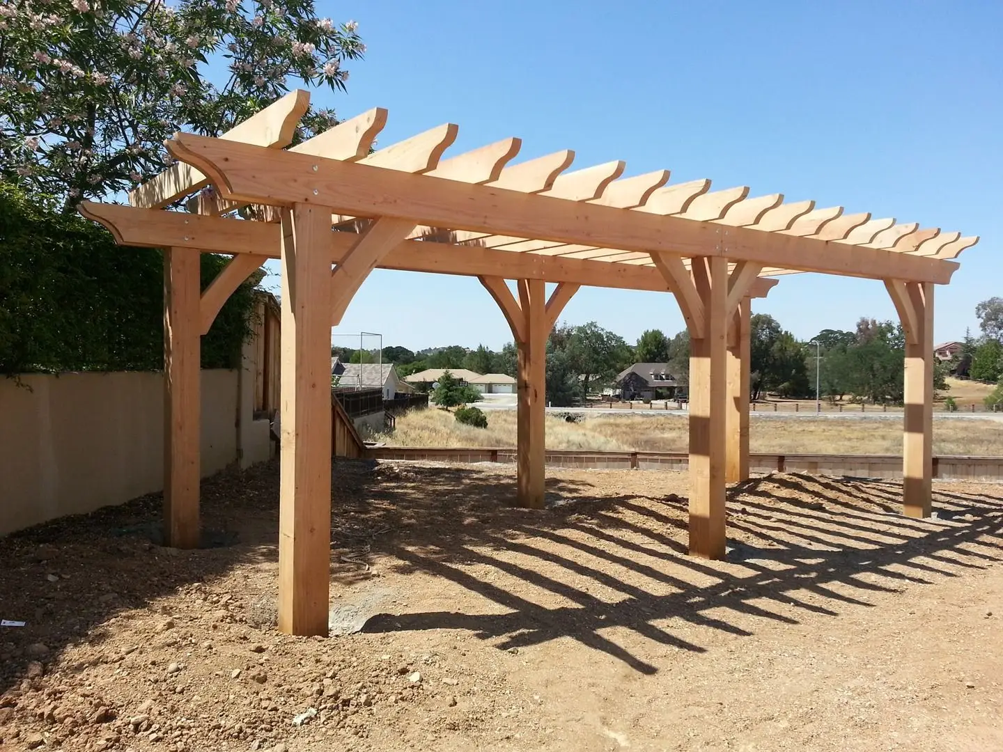 Rough-sawn timber pergola on a decomposed granite pad