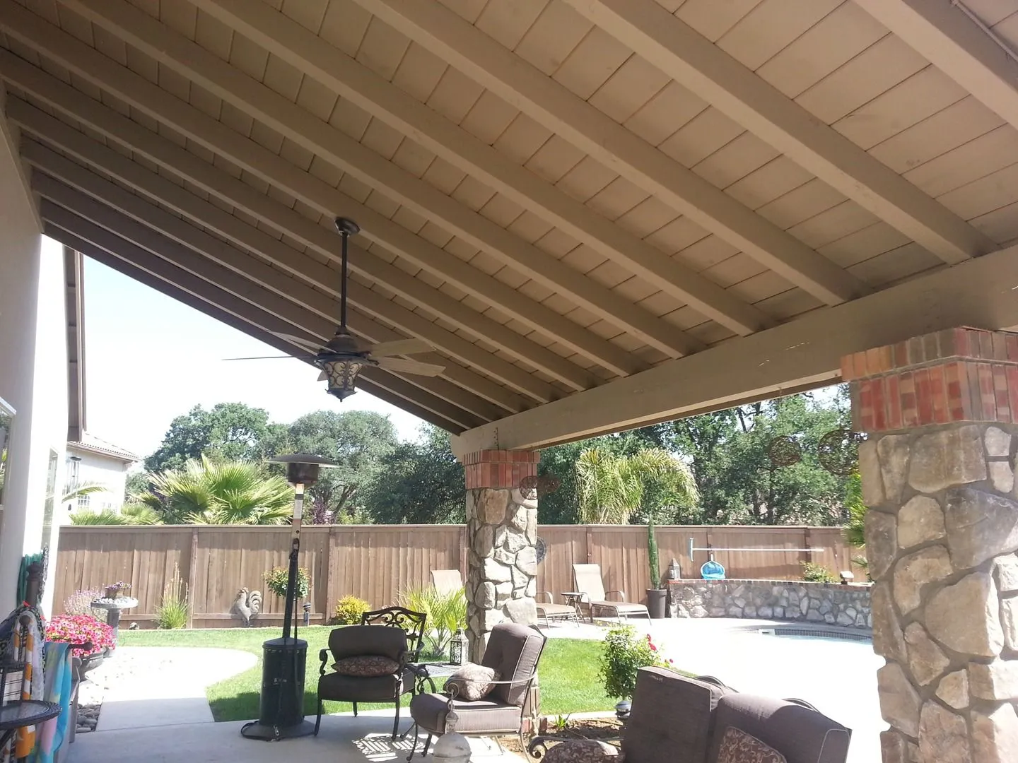 Solid timber patio cover with stone veneer columns