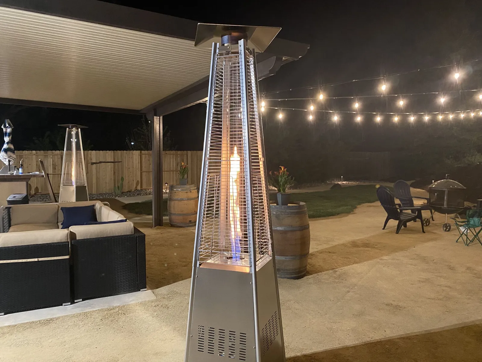 Covered patio at night with a patio heater and string lights