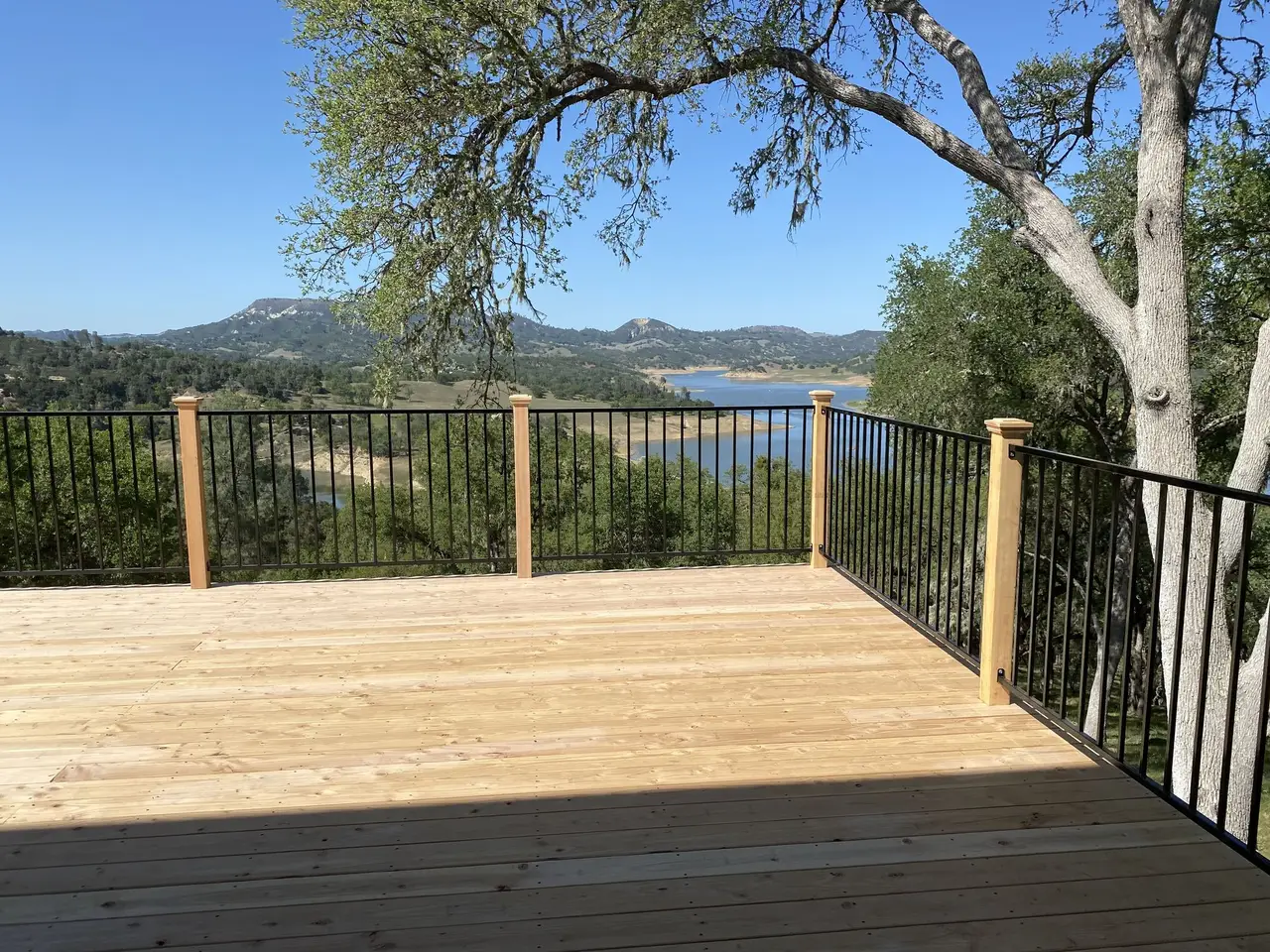 Pressure-treated wood deck with black metal railing